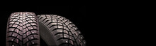 Winter Studded Tires On A Black Background, The Concept Of Safety And Tire Repair Tire Sales