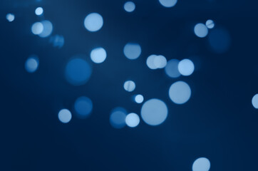 Wall Mural - blurry blue bokeh on a dark background