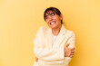 © Asier - Young Argentinian woman isolated on yellow background laughing and having fun.