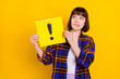 © deagreez - Portrait of attractive puzzled girl holding exclamation sign board biting lip isolated over bright yellow color background