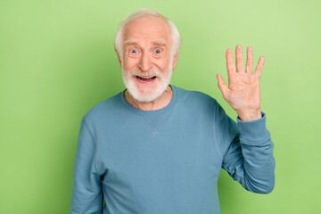 Sticker - Photo of impressed aged beard man wave wear blue sweater isolated on green color background