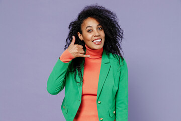 Wall Mural - Vivid smiling happy young black curly woman 20s years old wears green shirt looking camera doing phone gesture like says call me back isolated on plain pastel light violet background studio portrait.