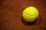 Fototapeta  - Tennis ball on the tennis court. Gravel. Tennis game. Sport, recreation concept