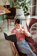 © chika_milan - A relaxed Asian girl sits in a coffee shop, drinks coffee, and reads a book.