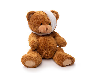 Wall Mural - medicine, healthcare and childhood concept - teddy bear toy with bandaged head having toothache on white background