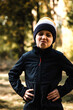 © Olha - The boy in the hat is grimacing. The boy is walking in the woods. Portrait of a boy