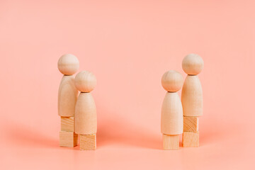 Abstract wooden toy figures people stand at different levels symbolizing social inequality and salary levels. Concept of employees in a team, banner format