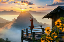Beautiful Girl Holding Storm Lantern Enjoying Morning Mist At Jabo Village, Mae Hong Son Province, Thailand.