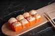 © Илья ивашкевич - a portion of rolls on a stand, japanese food, sushi on the table, chinese chopsticks, dark background