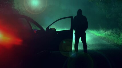Wall Mural - A science fiction concept of a man next to a car looking at a UFO floating above a road. On a scary forest road at night.
