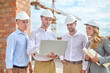 © zinkevych - Woman and men looking at laptop at construction