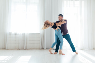 woman and man dancing to bachata music