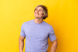 © luismolinero - Handsome blonde man isolated on yellow background thinking an idea while looking up