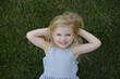 © triocean - Portrait of cute little girl laying on the grass