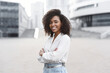© kite_rin - Young businesswoman in a city looking at camera, African american student girl portrait, Young woman with crossed arms smiling, People, enjoy life, student lifestyle, city life, business concept