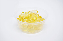 Gold Fish Oil In Isolated For Good Health On White Background With Selective Focus. Supplementary Food. Omega 3. Vitamin E   