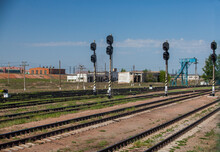 Old Soviet Railway Station In Industrial Zone. Traffic Lights, Industrial Buildings, Electric Poles. Blue Sky.