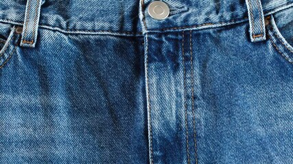 Wall Mural - Denim pants, front upper part, moving sideways, close-up macro, top view.