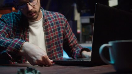 Hacker using usb flash drive close-up. Young man developing program, IT-specialist. Professional programmer infecting system with cyber virus, trying to break password.