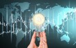 © BillionPhotos.com - Cryptocurrency concept. Businessman holding iluminated light bulb with bitcoin icon.