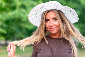 Portrait of happy cheerful positive beautiful girl, young attractive pretty woman with blonde hair, surprised amazed face in wicker summer hat looking at camera, smiling. Summertime, vacation concept