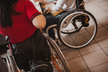 Wall Mural - Wheelchair wheels on which women with special needs sit in cafe. Accessible to person with special needs city and common areas