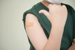 © DragonImages - Cropped image of boy showing adhesive plaster he has on shoulder after vaccine injection
