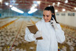 © cherryandbees - woman veterinarian inspecting poultry in chicken farm
