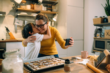 Wall Mural - mother and child in kitchen, preparing cookies