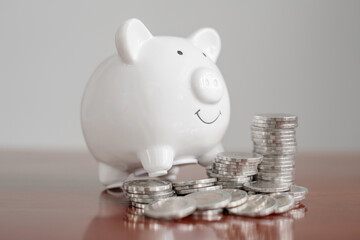 piggy bank with golden coins pile, step up growing business to success, and saving for retirement concept