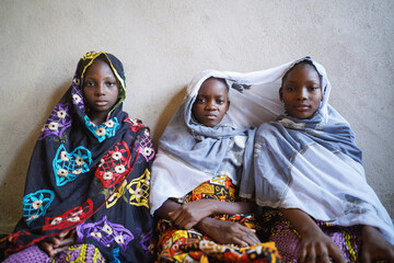 Poster - Three beautiful african girls pose by wall