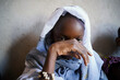 Poor little African girl covering her face ashamed