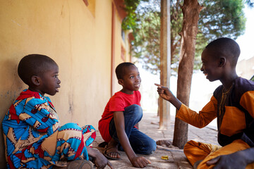 Three african boy friends have fun together outdoors