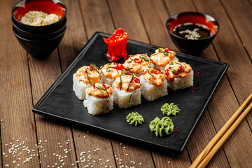 Wall Mural - Cheese ebi sushi rolls with wasabi and soy sauce on wooden background