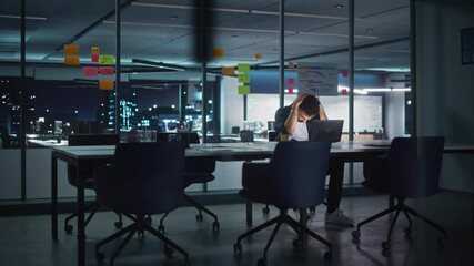 Wall Mural - Successful Handsome Innovative CEO Working on Laptop Computer in Big City Office Late in the Evening. Businessman Preparing for a Meeting Discussion with Investment Partners in Conference Room.