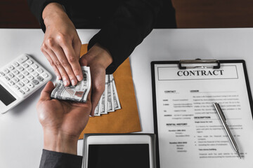 Wall Mural - Businessmen or politicians agree to accept bribes given in envelopes. To do illegal business, corruption in the contracting business, corruption concept and bribery.