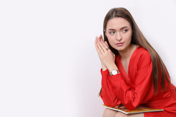 Sticker - Young woman with fashion magazine near white wall, space for text