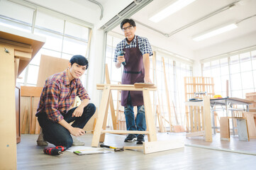 Wall Mural - wooden workshop concept, carpenter team craftsman person working with a wood work construction tool