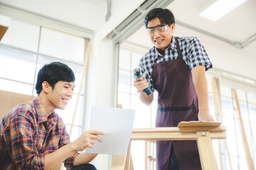 Wall Mural - wooden workshop concept, carpenter team craftsman person working with a wood work construction tool