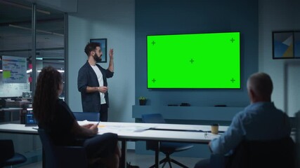 Aufkleber - Company Operations Manager Holds Meeting Presentation for a Team of Economists. Adult Male Uses Wide TV Set with Horizontal Green Screen Mock Up Display. People Work in Business Office.