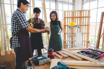 Wall Mural - wooden workshop concept, carpenter team craftsman person working with a wood work construction tool