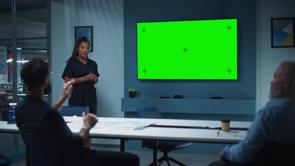 Aufkleber - Company Operations Manager Holds Meeting Presentation for a Team of Executives. Multiethnic Female Uses Wide TV Set with Horizontal Green Screen Mock Up Display. People Work in Business Office.