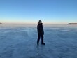 © Никита Родионов - a man in a winter jacket ice skating on the frozen Volga river