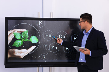 Sticker - Teacher using interactive board in classroom during lesson