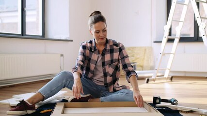 Wall Mural - repair, improvement and furniture concept - woman unpacking new locker details at home