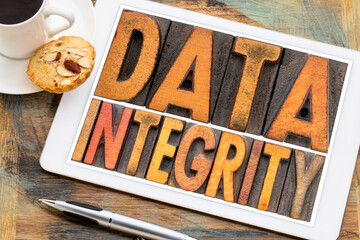 Canvas Print - data integrity isolated word abstract in vintage letterpress wood type on a digital tablet with coff