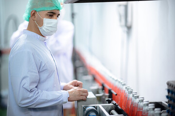 food technician control checking production line of water drink in manufacturing factory