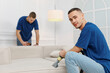© Josep - Two cleaning service workers happily cleaning a sofa