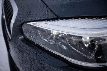 Detail close up view of the LED adaptive head light of premium luxury sedan car. Automotive lighting technology detail.