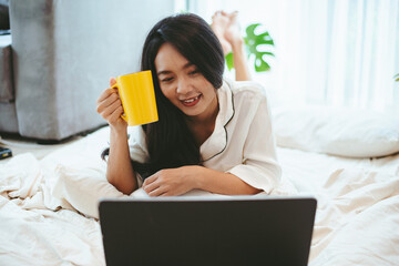 young Asian woman freelance working business work on laptop at home, working from home concept